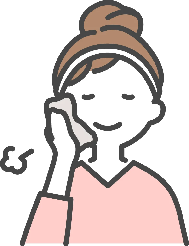 冷たいタオルで頬を冷やす女性