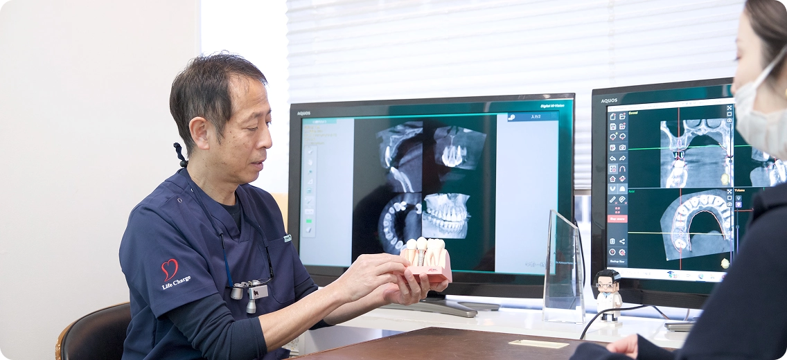 患者に模型を用いて説明する様子