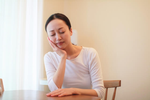 痛みに顔を歪める女性